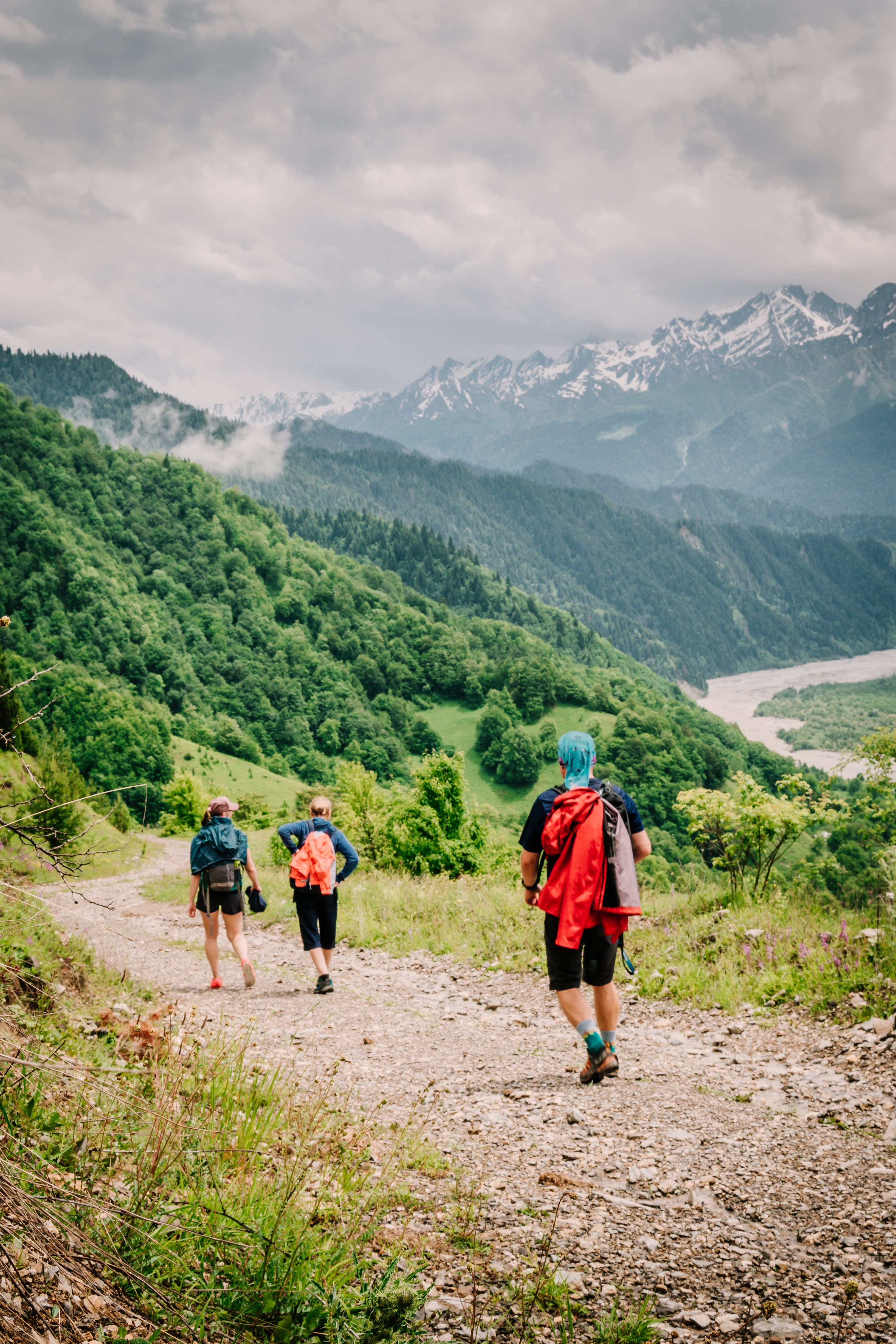 Hikers on an alpine trail above the Racha valley near Chiora